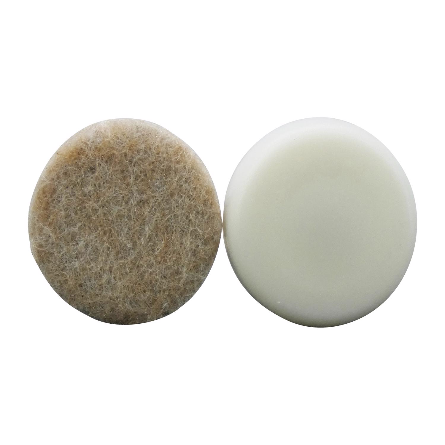 Two round felt pads side by side, one worn