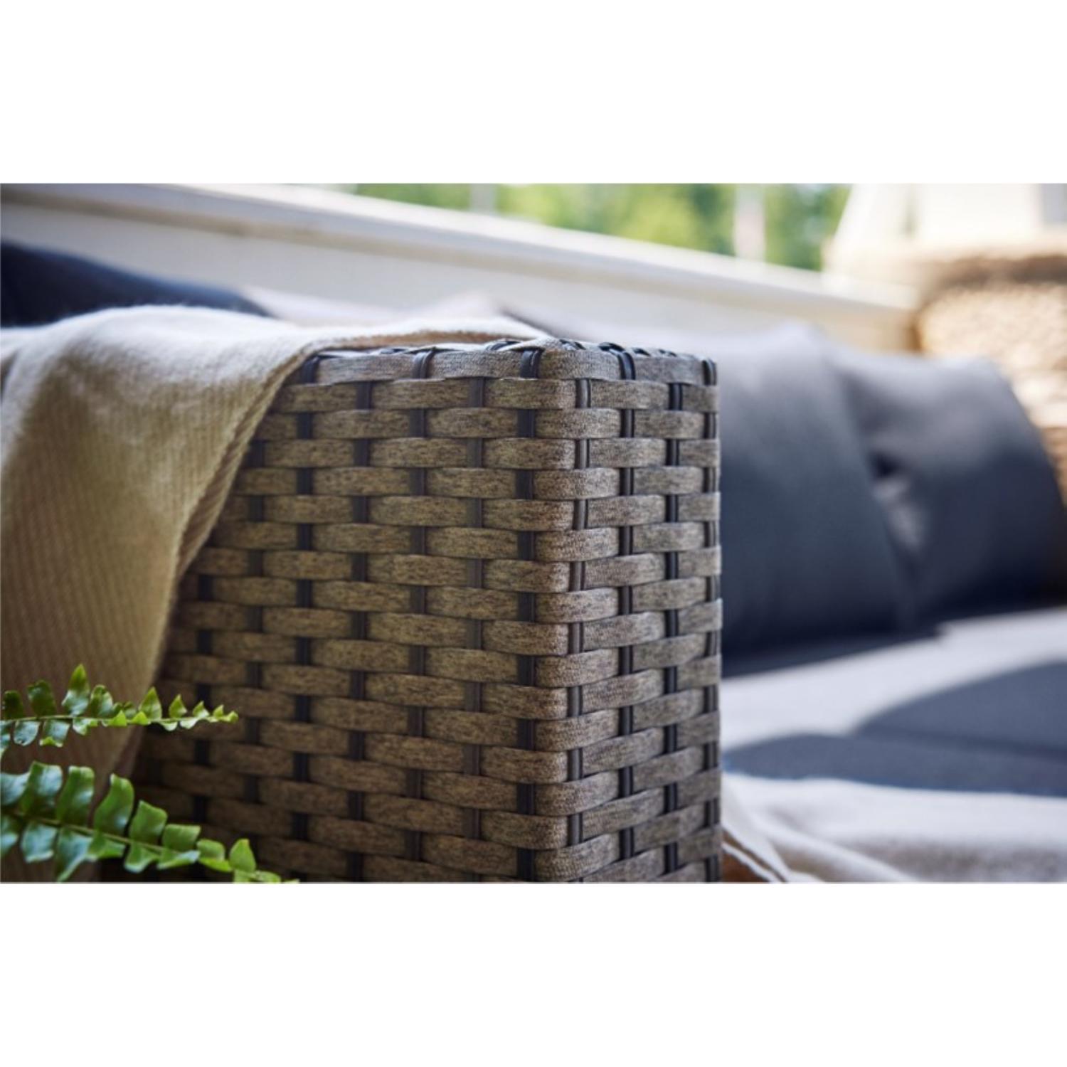 Close-up of woven wicker arm of outdoor furniture